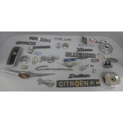 639 - A collection of car badges and name plates