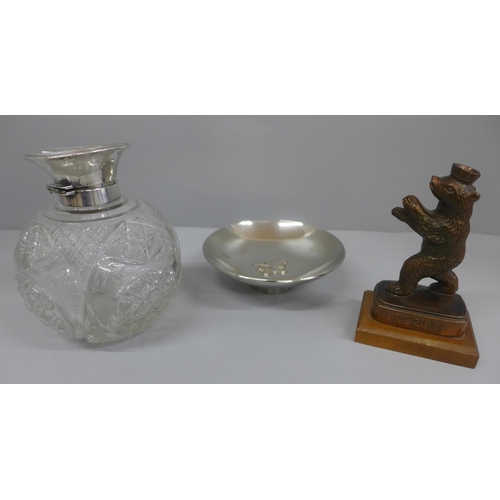 642 - A silver topped glass scent bottle, hinge a/f, a dish marked 24K GP and a metal model of a bear, Ber... 