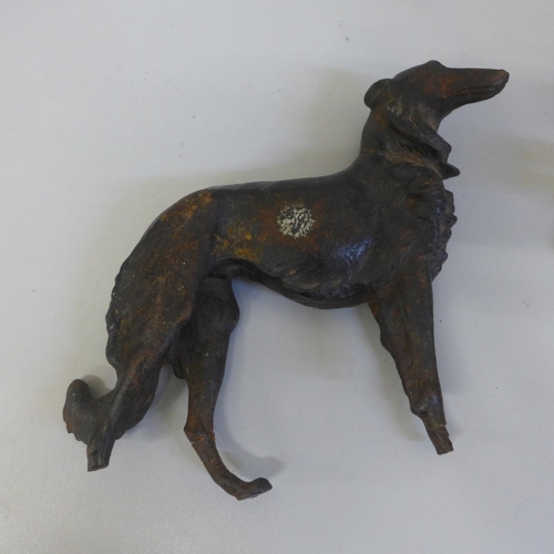 680 - A cast metal figure of a Borzoi, a/f and two brass figures, winged dog and lamb by a tree