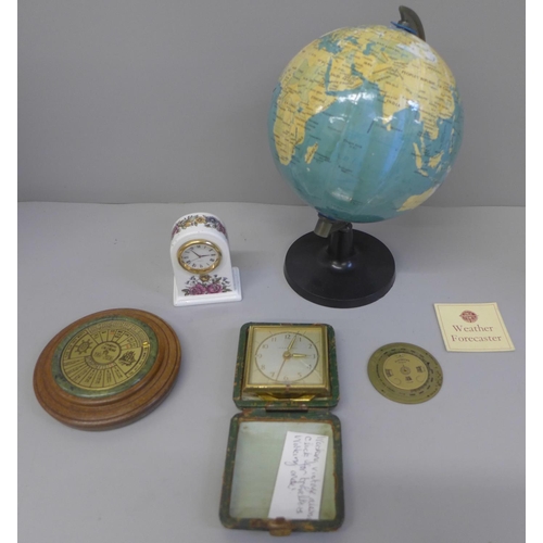 752 - A small globe, clock, travel clock, a 40 year calendar and a pocket brass barometer guide/forecaster