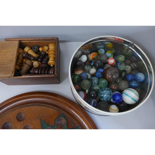 794 - A tin of vintage marbles and a Solitaire board, a chess set with board and draughts pieces