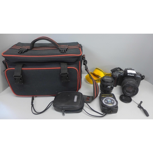 816 - A Nikon AF F-600 camera with additional 35-70mm lens, a light meter and bag