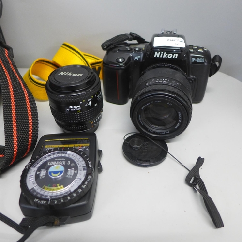 816 - A Nikon AF F-600 camera with additional 35-70mm lens, a light meter and bag