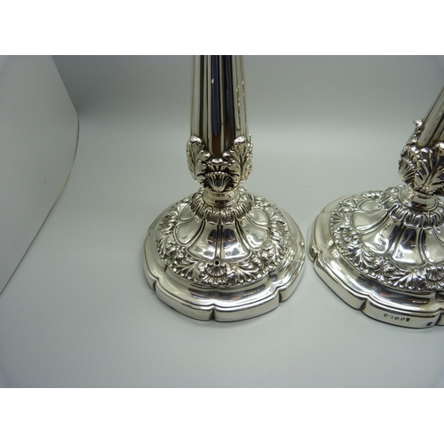 912 - A pair of 19th Century silver candlesticks, Sheffield 1824, Waterhouse, Hodson & Co., 25.5cm, some a... 