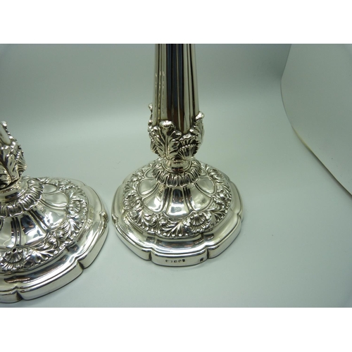 912 - A pair of 19th Century silver candlesticks, Sheffield 1824, Waterhouse, Hodson & Co., 25.5cm, some a... 