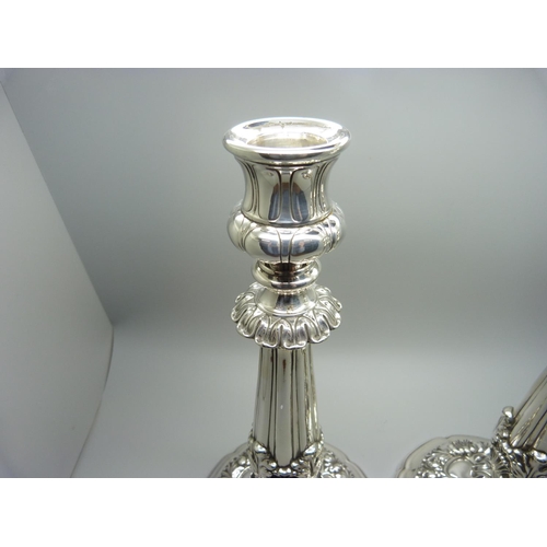 912 - A pair of 19th Century silver candlesticks, Sheffield 1824, Waterhouse, Hodson & Co., 25.5cm, some a... 