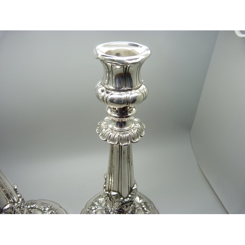 912 - A pair of 19th Century silver candlesticks, Sheffield 1824, Waterhouse, Hodson & Co., 25.5cm, some a... 