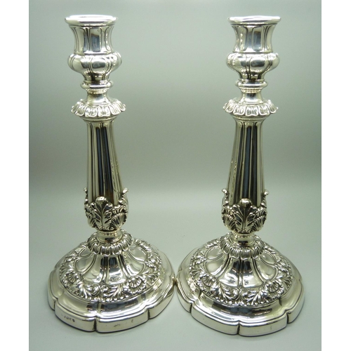 912 - A pair of 19th Century silver candlesticks, Sheffield 1824, Waterhouse, Hodson & Co., 25.5cm, some a... 