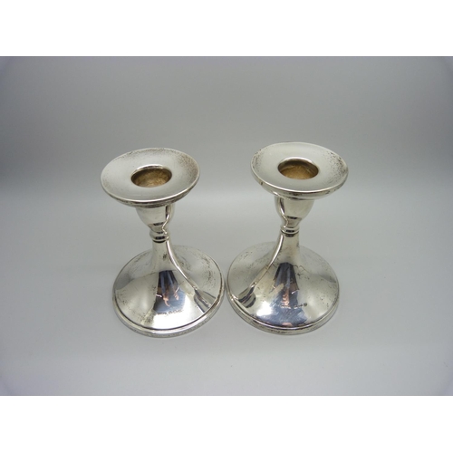 914 - A pair of silver candlesticks, Birmingham 1932/6, weighted bases