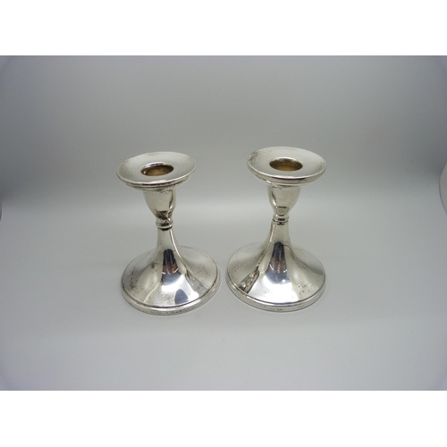 914 - A pair of silver candlesticks, Birmingham 1932/6, weighted bases