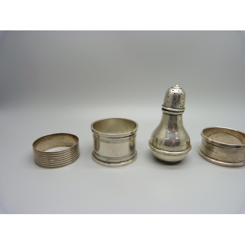 924 - Five silver napkin rings and a silver pepperette, 118g