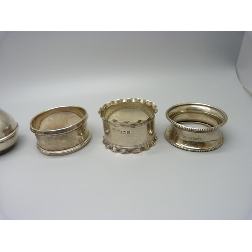 924 - Five silver napkin rings and a silver pepperette, 118g