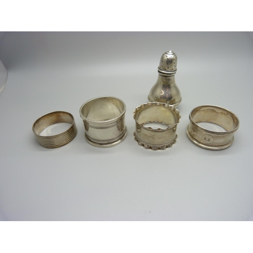 924 - Five silver napkin rings and a silver pepperette, 118g