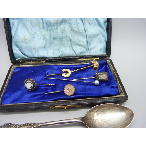 935 - Two silver spoons, a silver pin and five other pins, spoons 31g