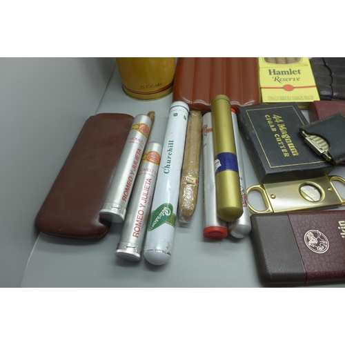 966 - A collection of cigars and cigar cutters, some cigars in individual tubes