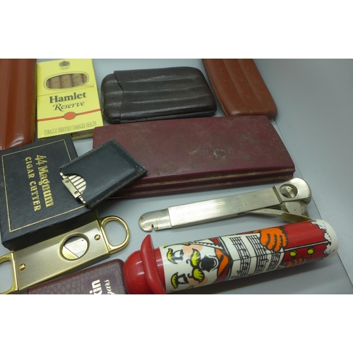 966 - A collection of cigars and cigar cutters, some cigars in individual tubes