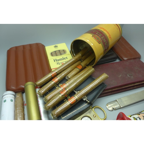 966 - A collection of cigars and cigar cutters, some cigars in individual tubes