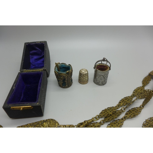 980 - A metal chatelaine, a cut steel thimble holder, a metal thimble holder with thimble, etc.