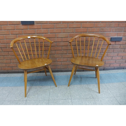 1 - A pair of Ercol Blonde elm and beech cow horn chairs