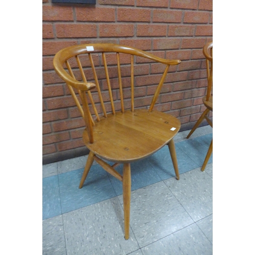 1 - A pair of Ercol Blonde elm and beech cow horn chairs