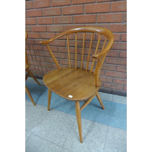 1 - A pair of Ercol Blonde elm and beech cow horn chairs