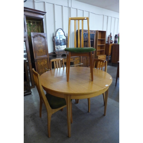 10 - A Sutcliffe of Todmorden teak extending dining table and four chairs