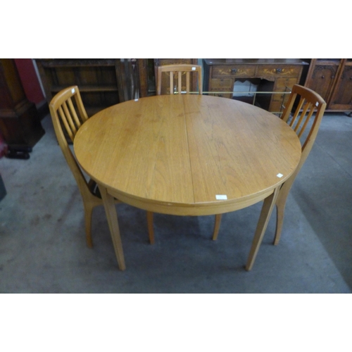 10 - A Sutcliffe of Todmorden teak extending dining table and four chairs