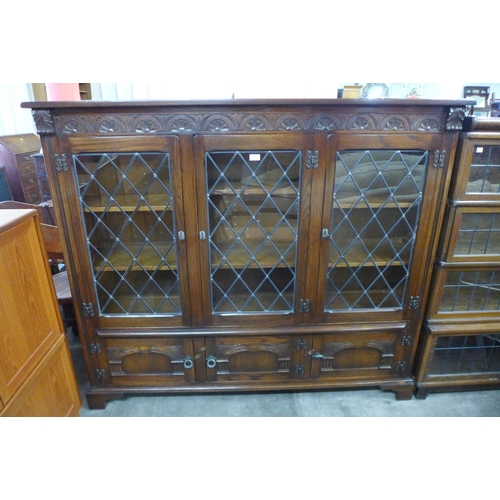 109 - A carved oak three door bookcase