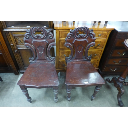 116 - A pair of Victorian mahogany hall chairs