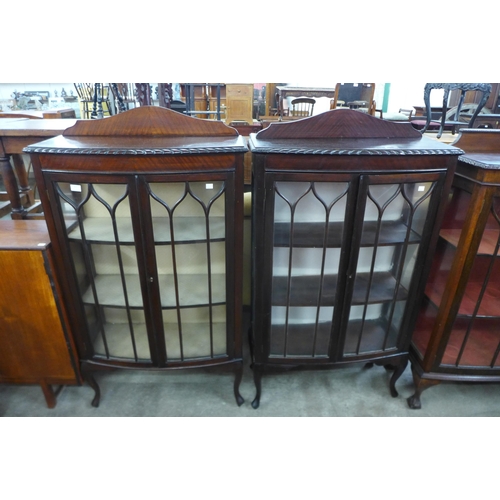 127 - A pair of mahogany bow front two door display cabinets