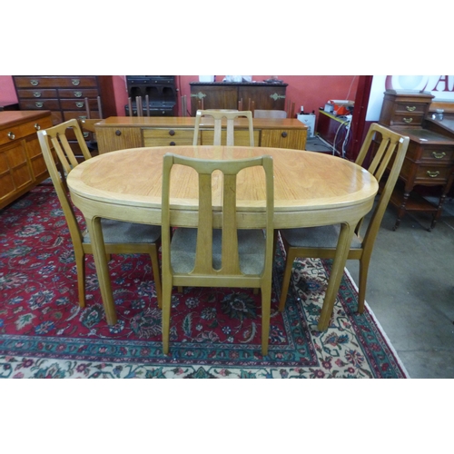 31 - A Nathan teak extending dining table and four chairs