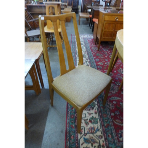 31 - A Nathan teak extending dining table and four chairs