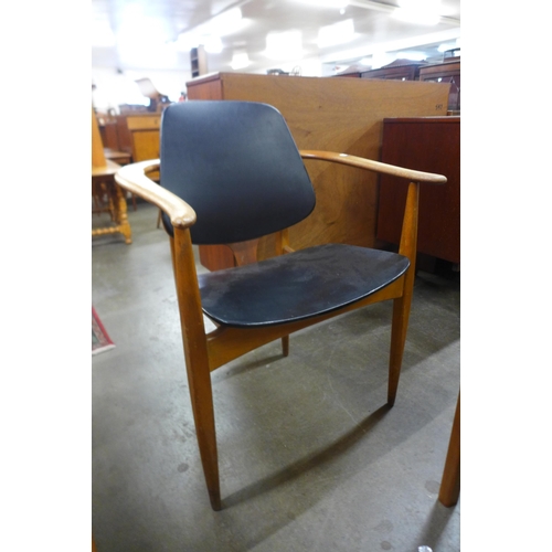 43 - An Elliotts of Newbury teak and black vinyl desk chair