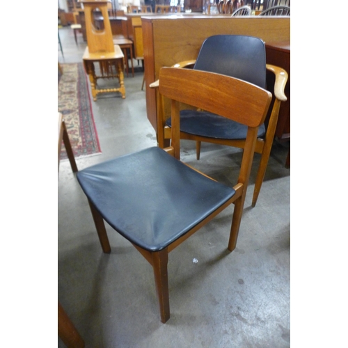 44 - A set of four teak and black vinyl dining chairs