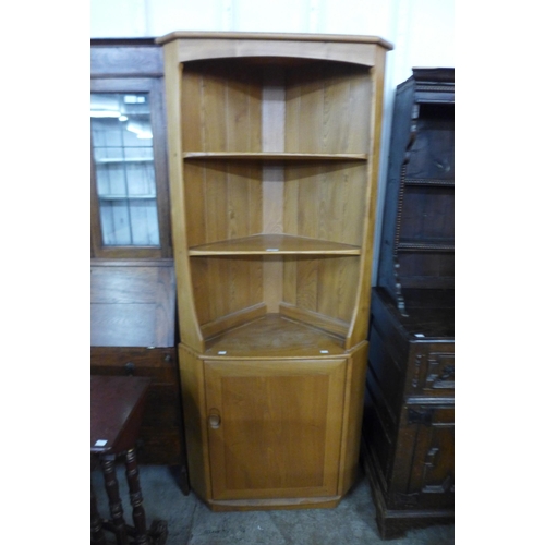 47 - An Ercol Blonde ash corner cabinet