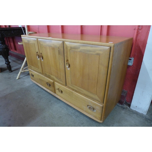 6 - An Ercol Blonde elm and beech Windsor sideboard