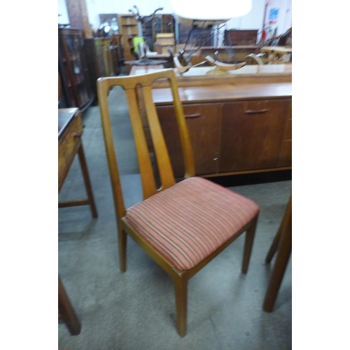 60 - A Nathan teak extending dining table and four chairs