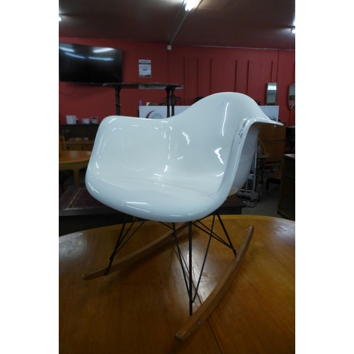 62 - An Eames style white perspex rocking chair