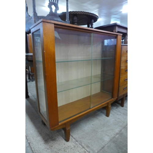 64 - A teak display cabinet