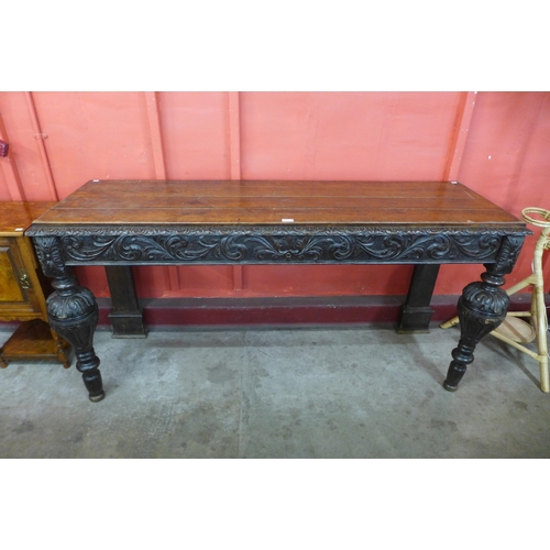 84 - A Victorian Elizabethan Revival carved oak serving table