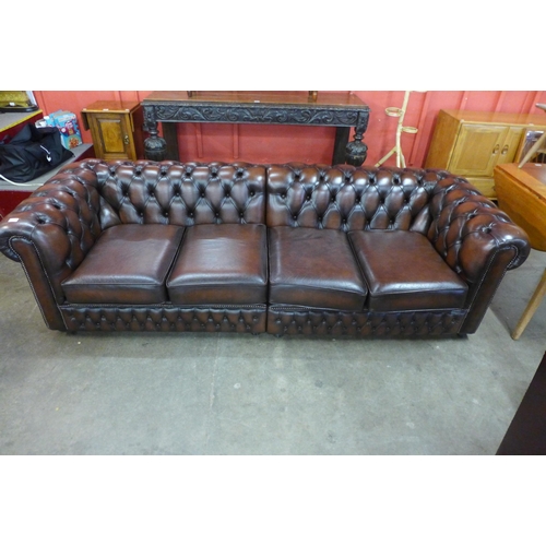 88 - A chestnut brown leather Chesterfield settee