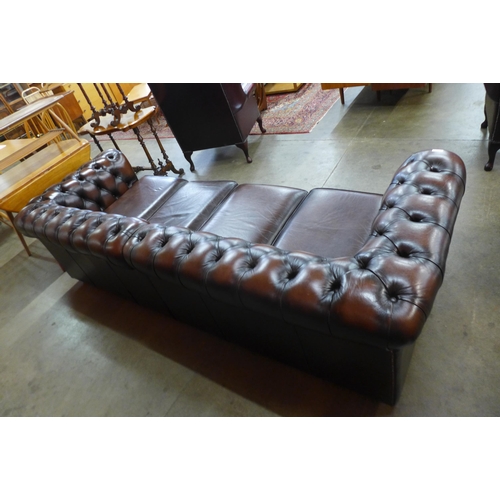 88 - A chestnut brown leather Chesterfield settee