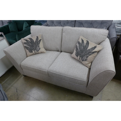 1403 - A beige textured weave three seater sofa