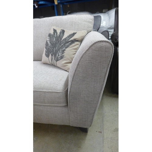 1403 - A beige textured weave three seater sofa