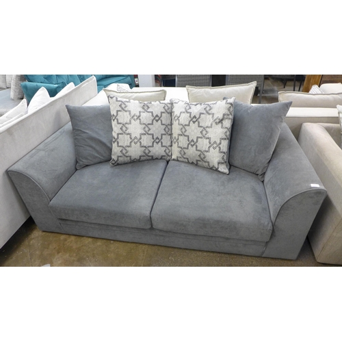 1412 - A grey upholstered three seater sofa with patterned cushions and footstool