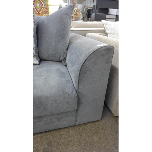 1412 - A grey upholstered three seater sofa with patterned cushions and footstool