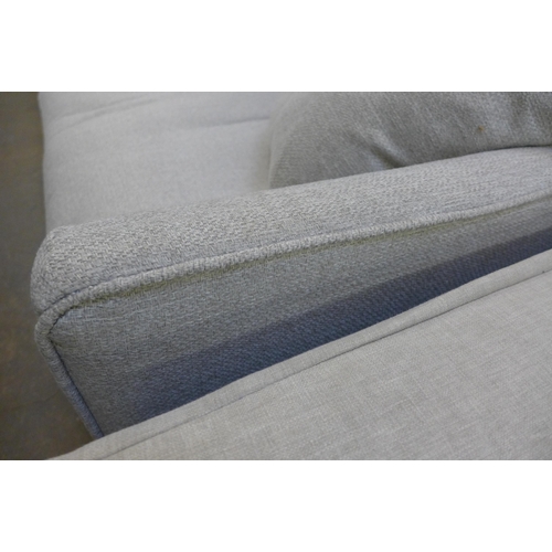 1450 - A dove grey upholstered four seater sofa