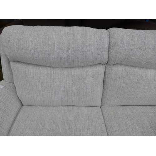 1461 - A champagne and grey fleck high back three seater sofa