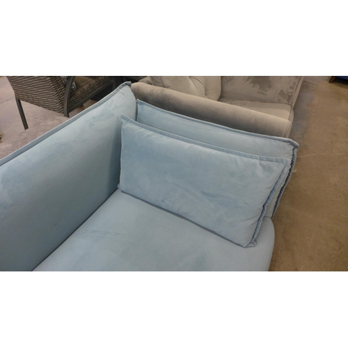 1426 - A sky blue velvet four seater sofa with chrome feet