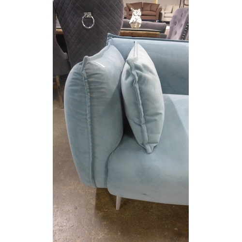 1426 - A sky blue velvet four seater sofa with chrome feet